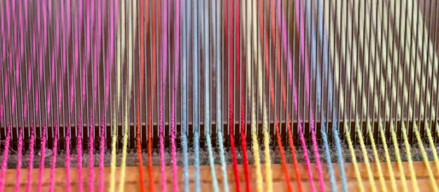 Hilos de colores en un telar textil